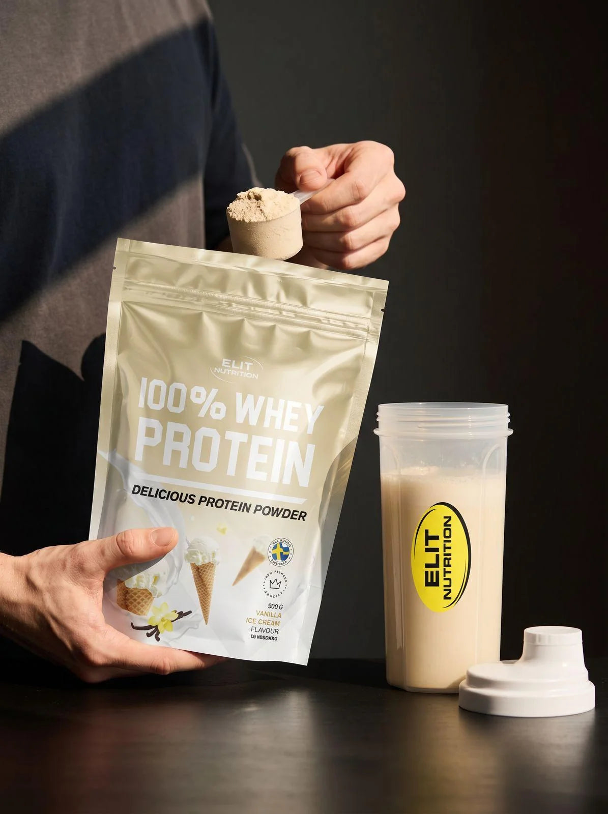Elit Nutrition whey and shaker, photographed for the brand